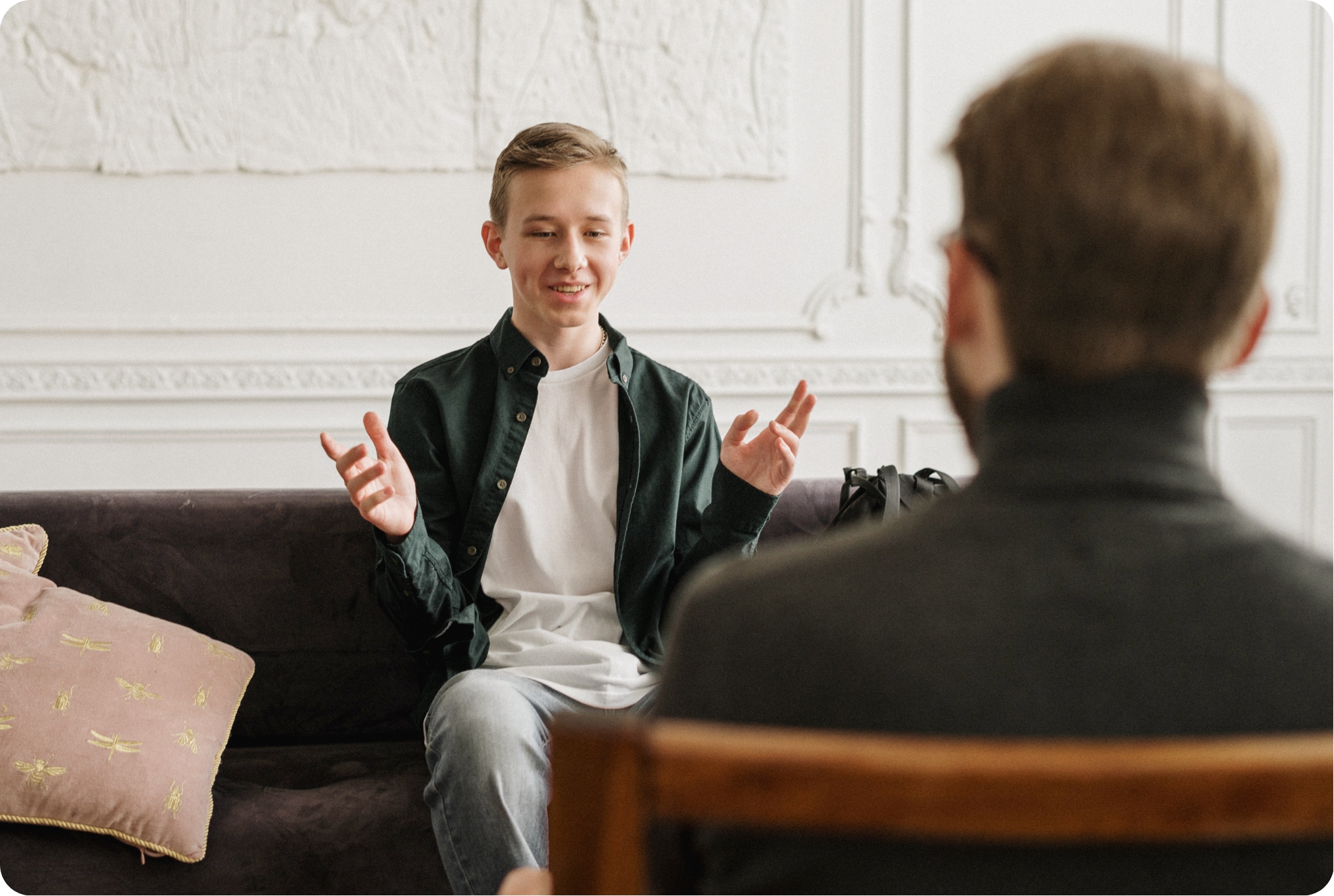 Therapist and client talking on a couch